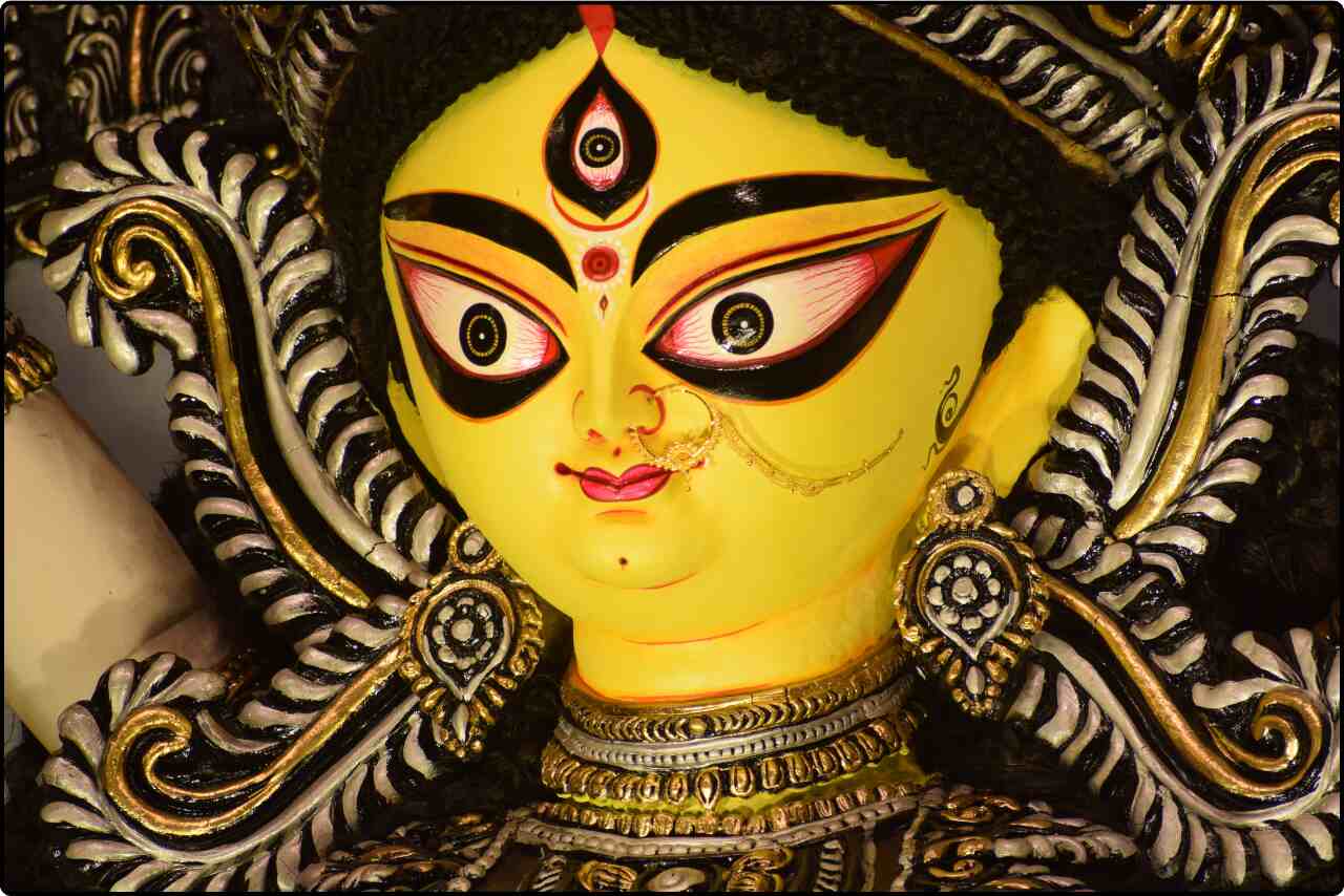 Portrait close-up photograph emphasizing the facial features of a Durga statue.